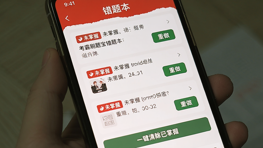 主体:手机屏幕显示考霸刷题宝“错题本”页面,列表中有三道错题,每道题都有红色“未掌握”标签和“重做”按钮,底部有“一键清除已掌握”按钮。整体界面以白色为底,红色和绿色点缀。画质干净,无多余元素。